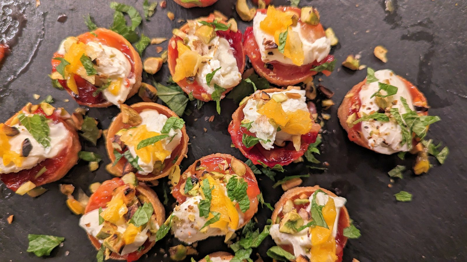 Roasted plums, marscapone, and pistachio canapes